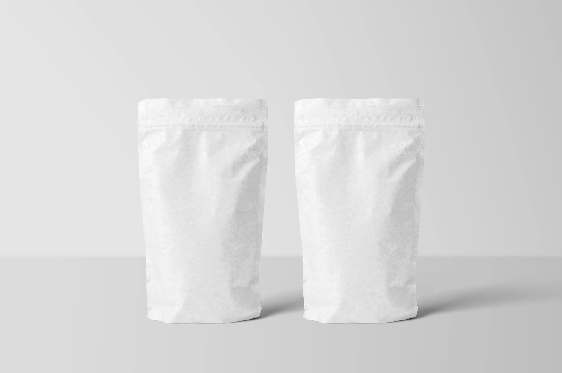 two stand up zipper pouch on white surface